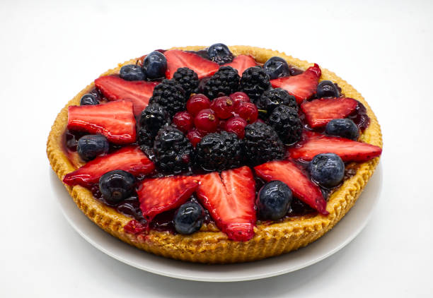 istock Fresh fruit tart with strawberries, raspberries, blackberries, isolated on white 1305029926