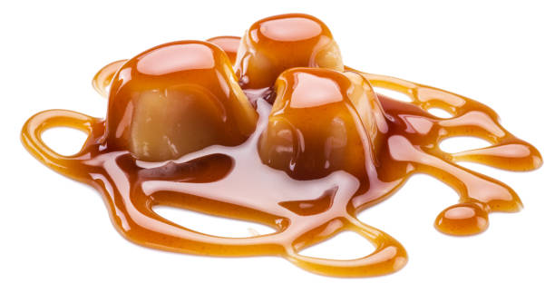 istock Caramel candies covered with melted sugar caramel isolated on white background. 1305032885