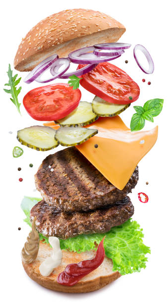 istock Tasty delicious hamburger ingredients flying in the air layer upon layer. Clipping path. 1305033024