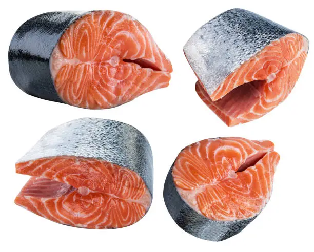 Photo of Four cuts of salmon fish isolated on white background. File contains clipping paths.