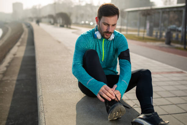 istock Runner trying running shoes getting ready for run 1305034580