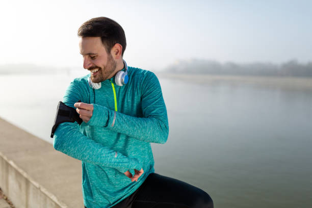 istock Running man checking sport performance on his mobile phone 1305034581