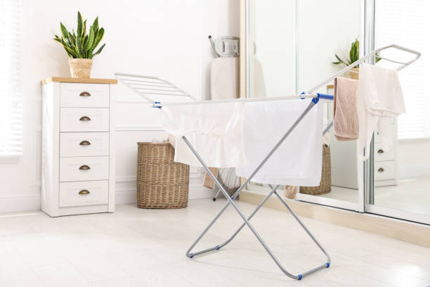clean laundry hanging on drying rack indoors - secar imagens e fotografias de stock