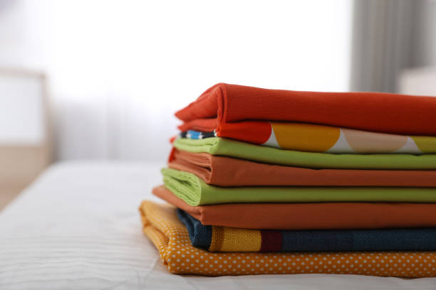 istock Clean color folded linens on bed indoors. Space for text 1305038701