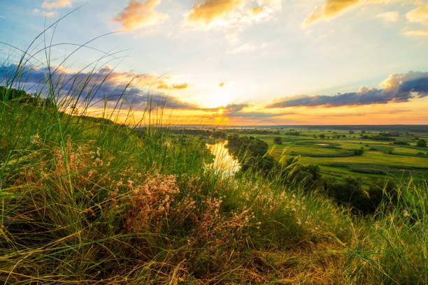istock A beautiful valley with a river, blue sky with large clouds and bright sun. Aerial 1305038785
