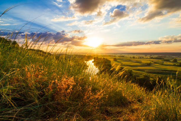 istock A beautiful valley with a river, blue sky with large clouds and bright sun. Aerial 1305038790