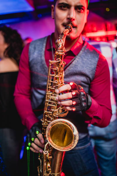 istock Saxophonist on club party 1305038928