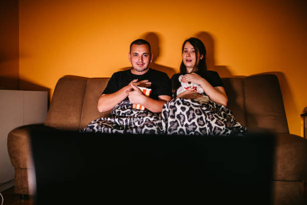istock Couple watching movie at home 1305039868