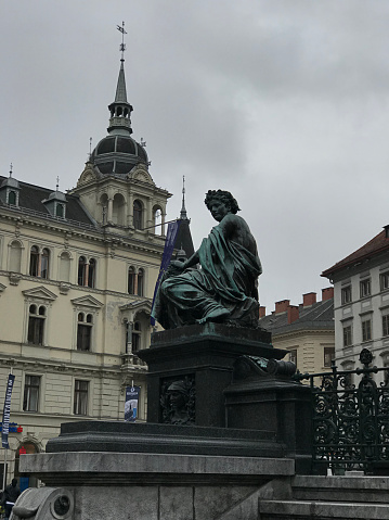 Graz, Austria - November 9, 2018:  One of four female figures of Erzherzog Johann fountain. It is situated at hauptplatz (main square) of Graz city in Austria. The fountain shows the Hapsburg surrouded by four female figures. They symbolize the rivers Mur, Enns, Drava and Sann which flew through Styria In her old boarders.
