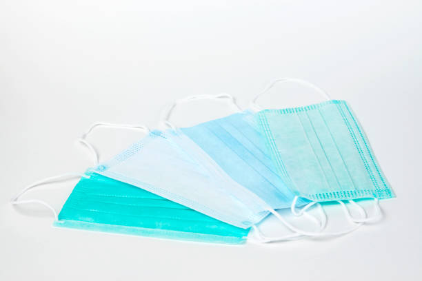 istock Surgical mask on white background, close-up. 1305049699