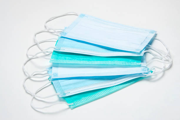 istock Surgical mask on white background, close-up. 1305049711