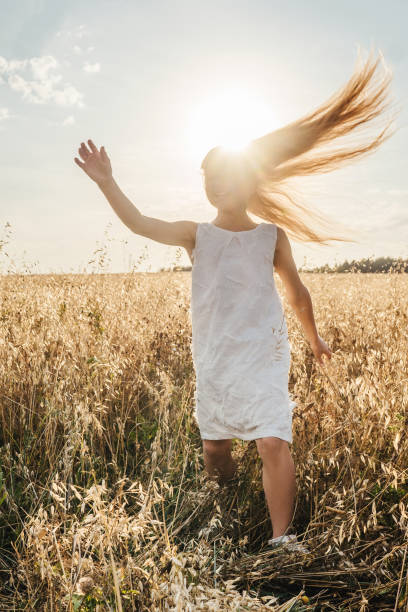 istock Little girl in field, sunset light. 1305051302