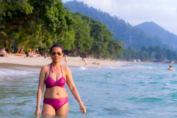 istock Woman shape sexy with bikini at beach 1305052756