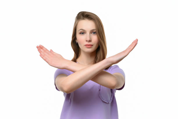 istock Serious young woman keeps two arms crossed, showing stop gesture while looking at camera. Denial concept 1305052916