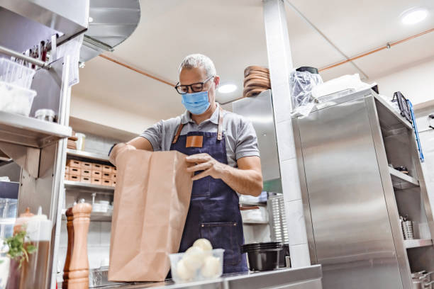istock Fast food restaurant delivering food with extra coronavirus precautions 1305053611