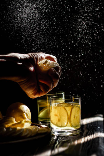 istock Fresh lemon juice. Moody splash background. 1305053682