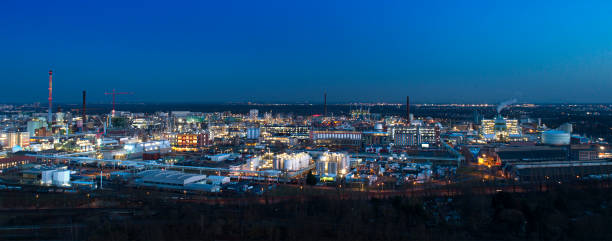 istock Large illuminated industrial district - aerial view at dusk 1305056034