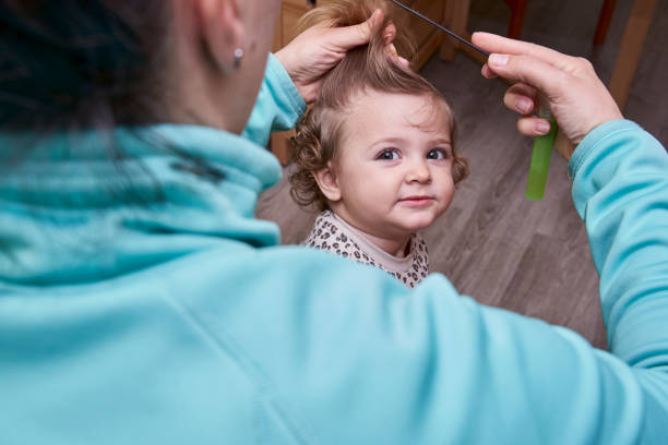 istock Toddler girl being combed by her mother 1305056421