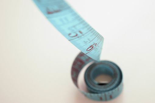 Blue tape measure in meters and inches in a spiral