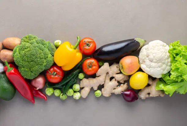 Fresh farm organic vegetables on gray background, healthy food concept, vegetables and superfood and green salad, top view, copy space