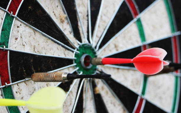 istock Darts target closeup. Success hitting target aim goal achievement concept 1305062708