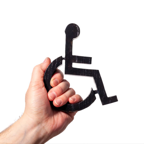 Disabled symbol being held up my a human hand. Power to disabled people sign on a white background