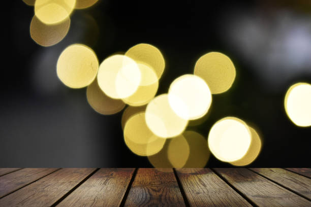 istock Empty wood table top and blur of night bokeh background 1305062857