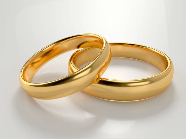 istock Wedding gold rings lie in each other isolated 1305064859