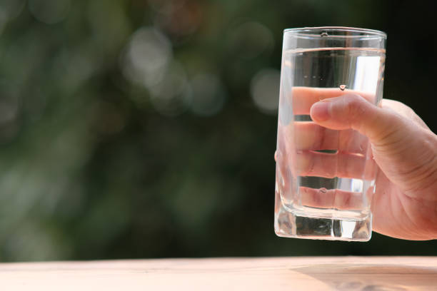 istock pouring drinking water and health care concept 1305066277