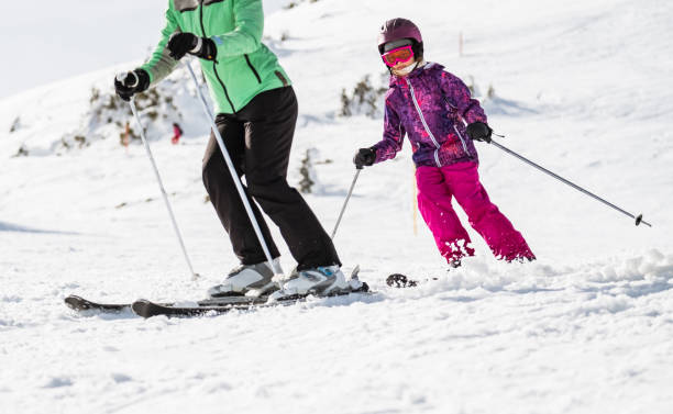 istock Mother and daughter on ski slope 1305067420