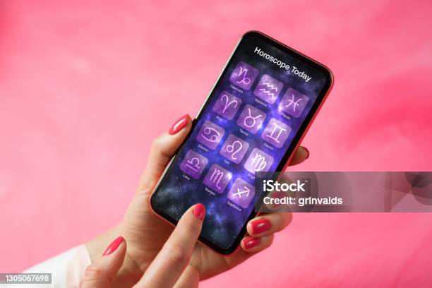 Person Reading Daily Horoscope On Mobile Phone Stock Photo - Download Image Now - Astrology, Astrology Sign, Women