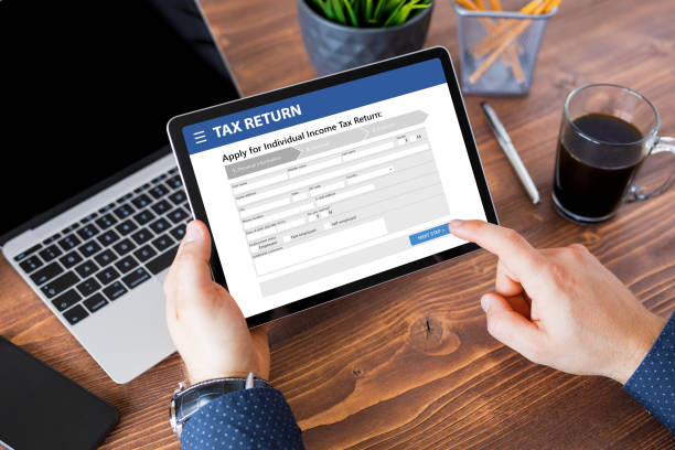 istock Man submitting individual income tax return form 1305068314