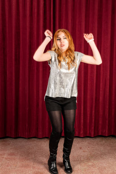 istock RedHead Woman dances on the theater stage 1305068536