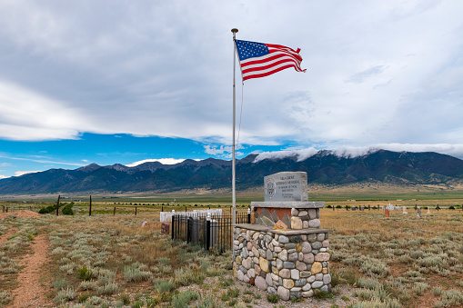 Villa Grove, Colorado - July 13, 2014: View of a cemetery (Villa Grove Veterans Memorial) with mountains on the background, near Villa Grove, in the State of Colorado, USA