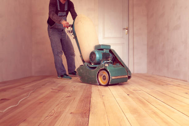 istock carpenter works by electric grinding wood machine in a room 1305076224