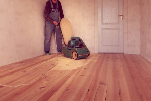 istock carpenter works by electric grinding wood machine in a room 1305076232