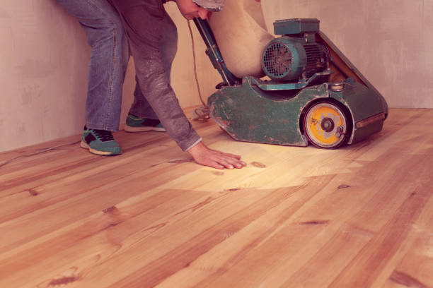 istock carpenter works by electric grinding wood machine in a room 1305076237