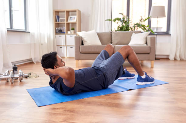 istock indian man making abdominal exercises at home 1305077838
