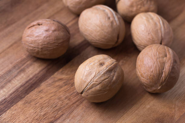 istock Some walnuts on a vintage wooden background 1305079129
