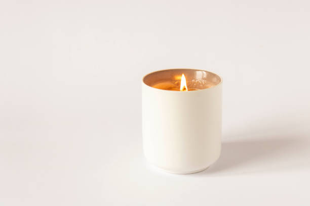 istock A burning candle on a light background. Close-up. Selective focus. 1305081144