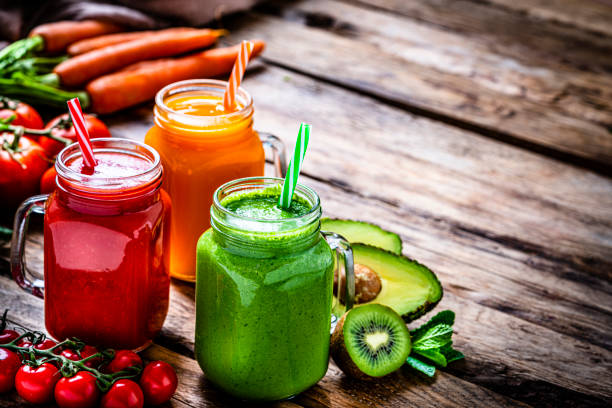 istock Healthy fruits and vegetables smoothies on rustic wooden table 1305081727