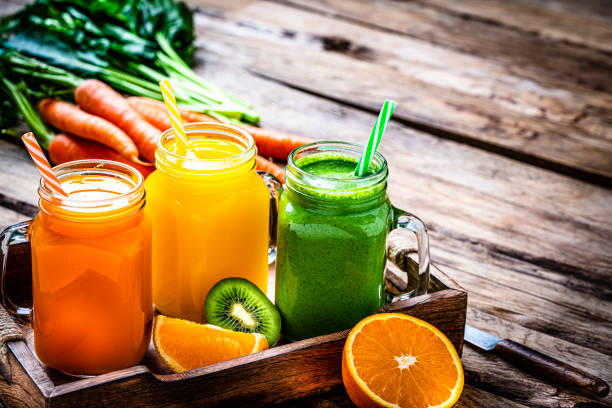 istock Healthy fruits and vegetables smoothies on rustic wooden table 1305081737