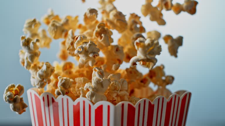 SLO MO LD Popcorn bouncing out of a striped box