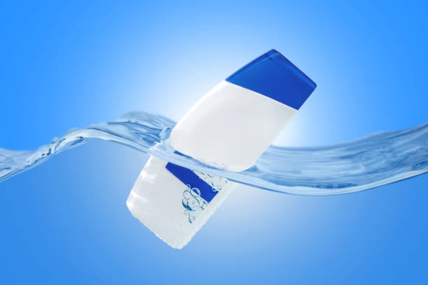 istock Plastic white bottle in the water on blue backround. 1305088202