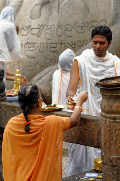 Family received prasad(Blessing) from priest  on Vindyagiri at Shravanbelagola in the Indian state of Karnataka