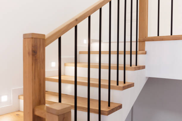 istock Wood staircase inside contemporary white modern house. 1305090865