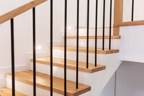 istock Wood staircase inside contemporary white modern house. 1305090881