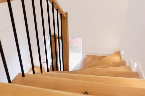 istock Wood staircase inside contemporary white modern house. 1305090890