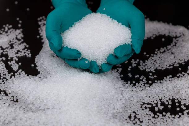 istock Close-up of plastic polymer granules. hand hold Polymer pellets. polymer plastic. compound polymer. Hands in rubber gloves hold plastic pellets. 1305092104