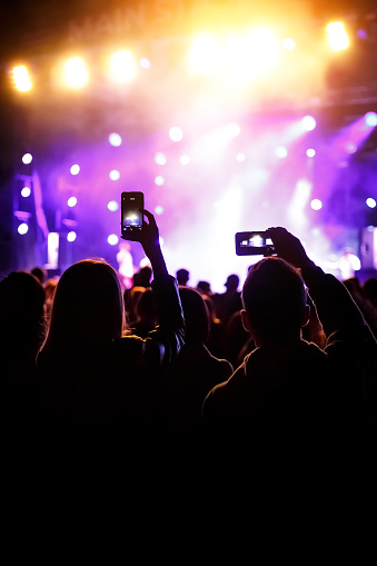 People holding their smart phones and photographing concert
